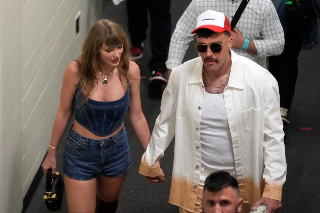 Travis Kelce, right, and Taylor Swift hold hands following the Chiefs win over the Baltimore Ravens Thursday, Sept. 5, 2024.